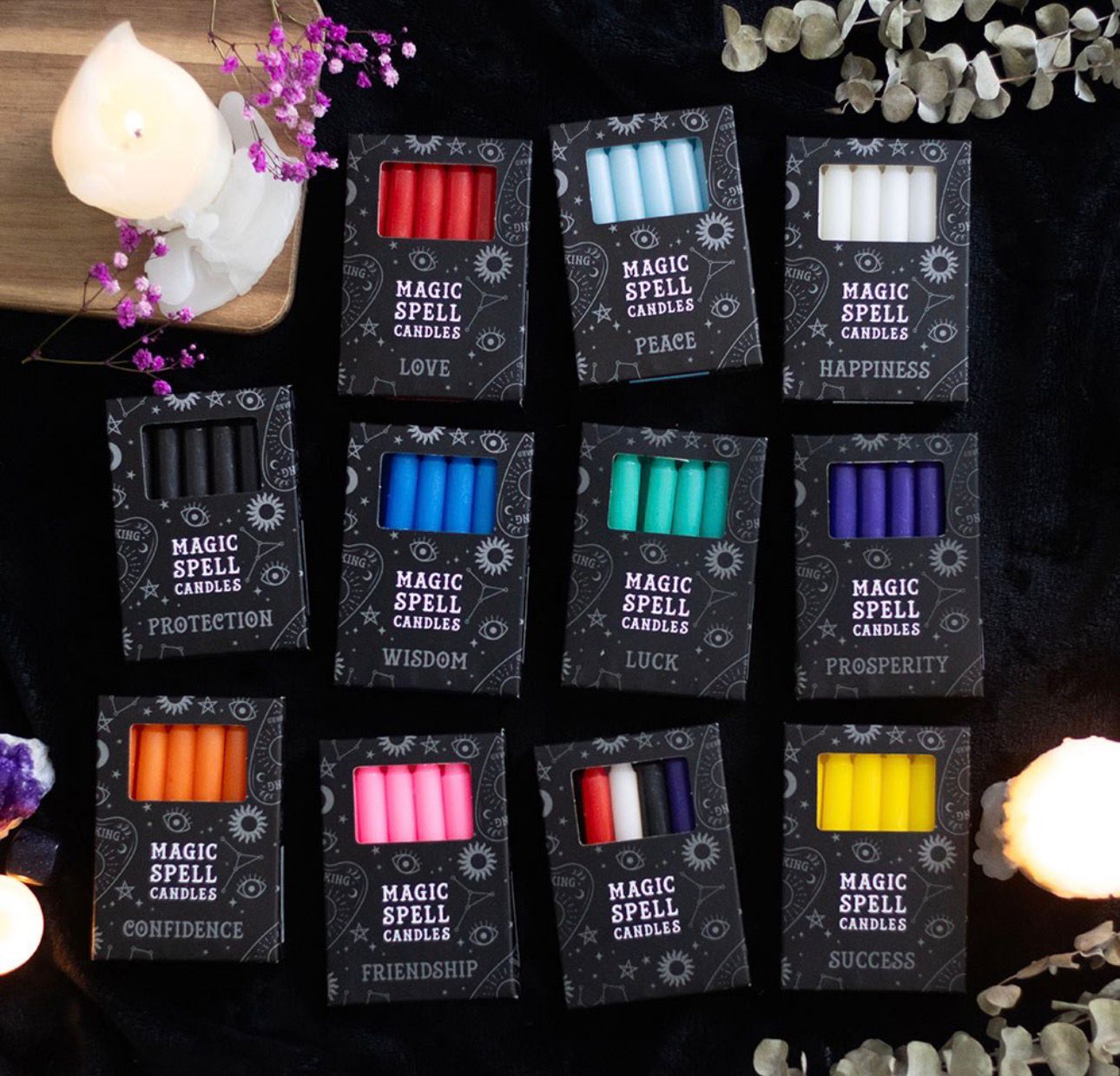 Paquete de 12 velas rituales disponibles en diferentes colores, cada uno con una intención específica